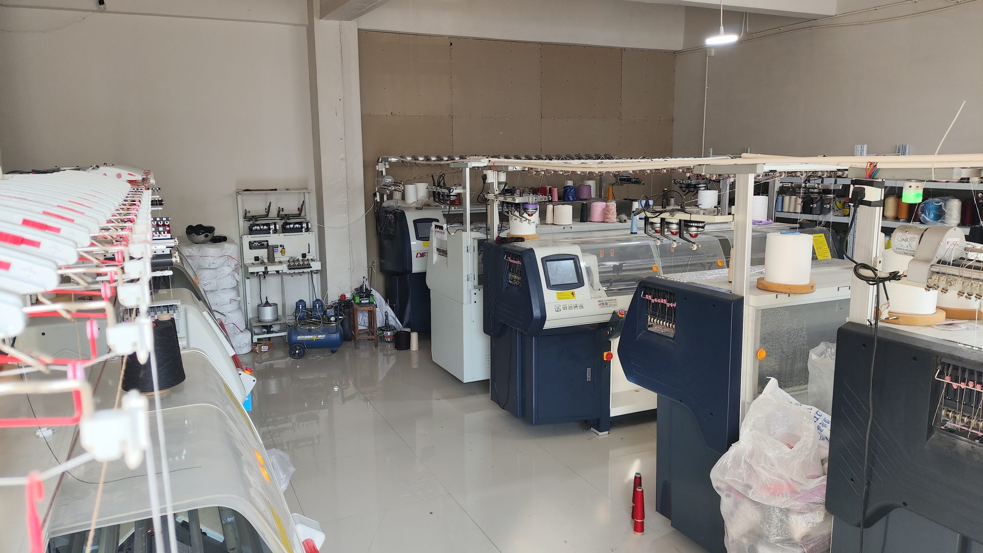 Rows of computer flat knitting machines in the Woolmoor workshop